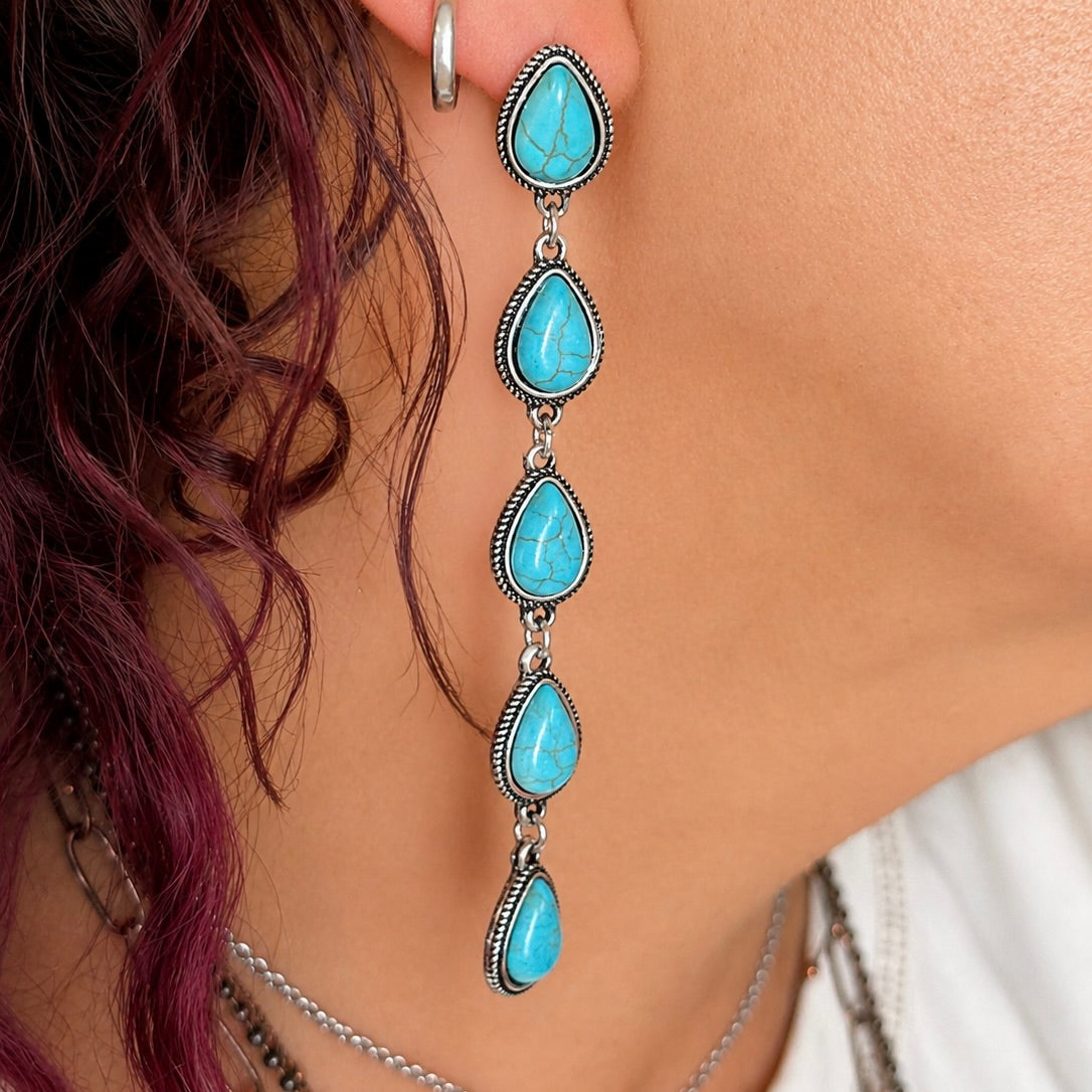 Turquoise teardrop dangle earrings with silver-tone links and scalloped bezels