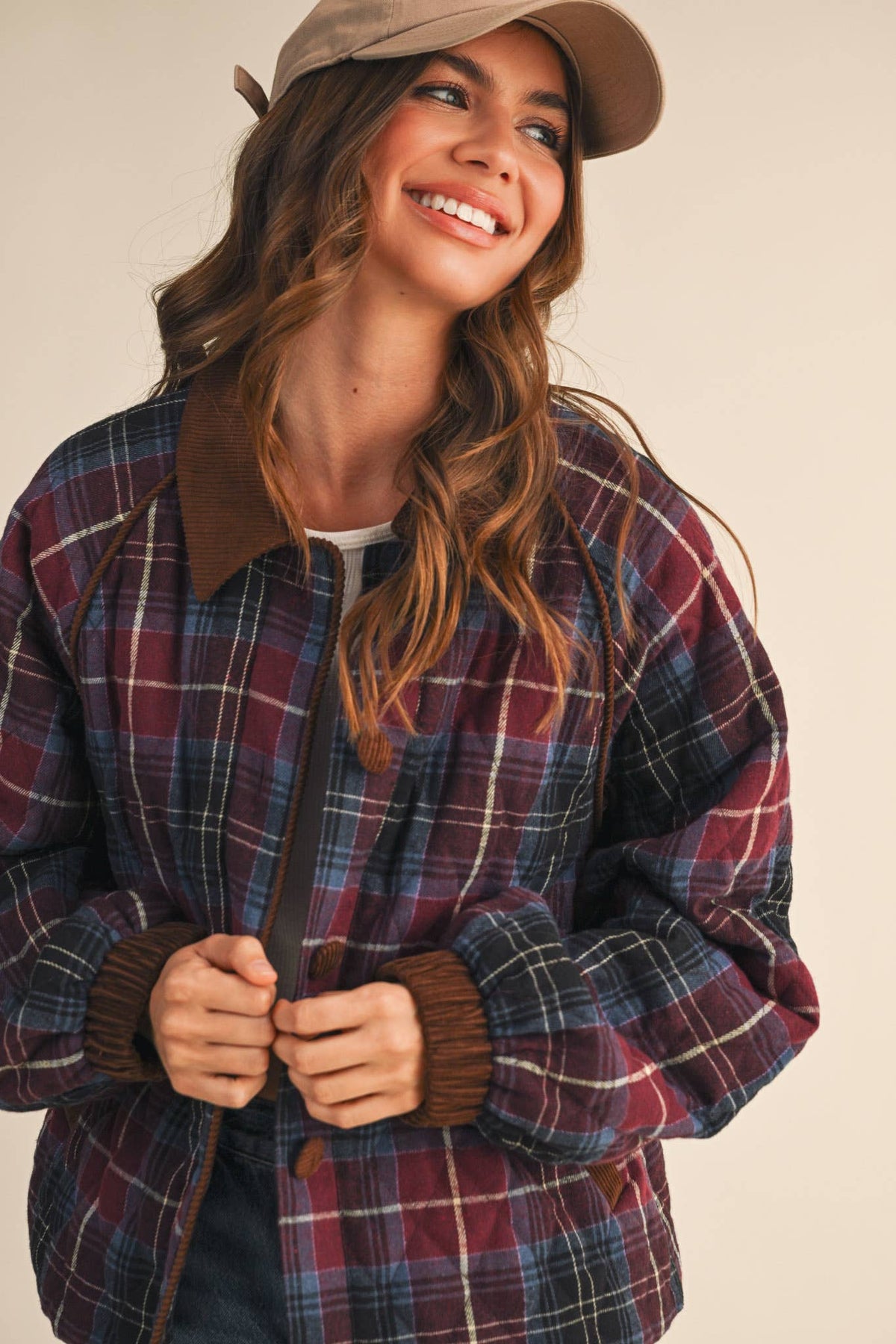 Plaid quilted jacket in multi colors with dark corduroy-trim collar and button front.